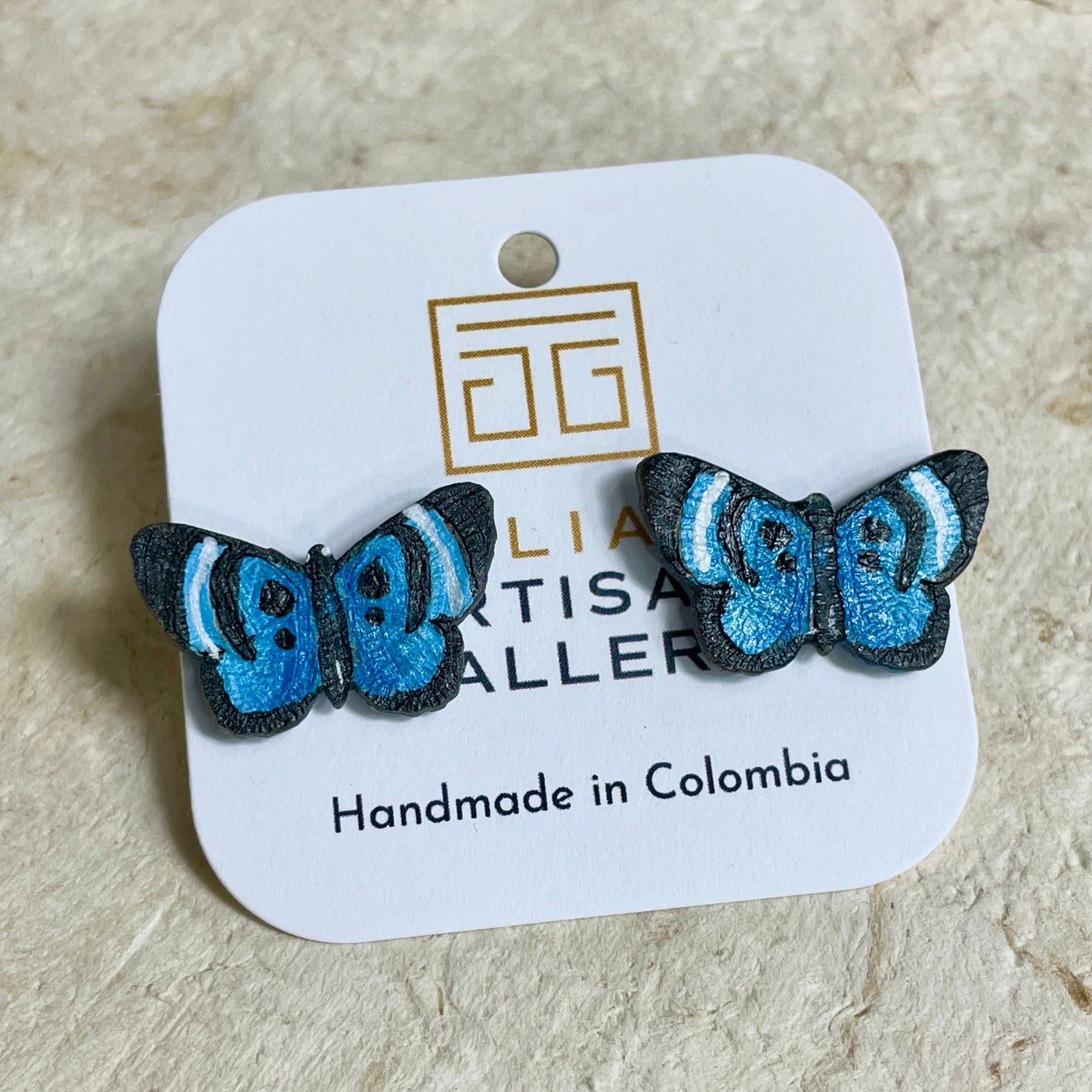 Blue butterfly earring studs in package.