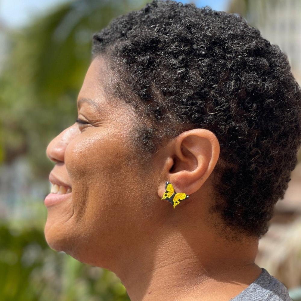 Model wearing yellow butterfly earring studs