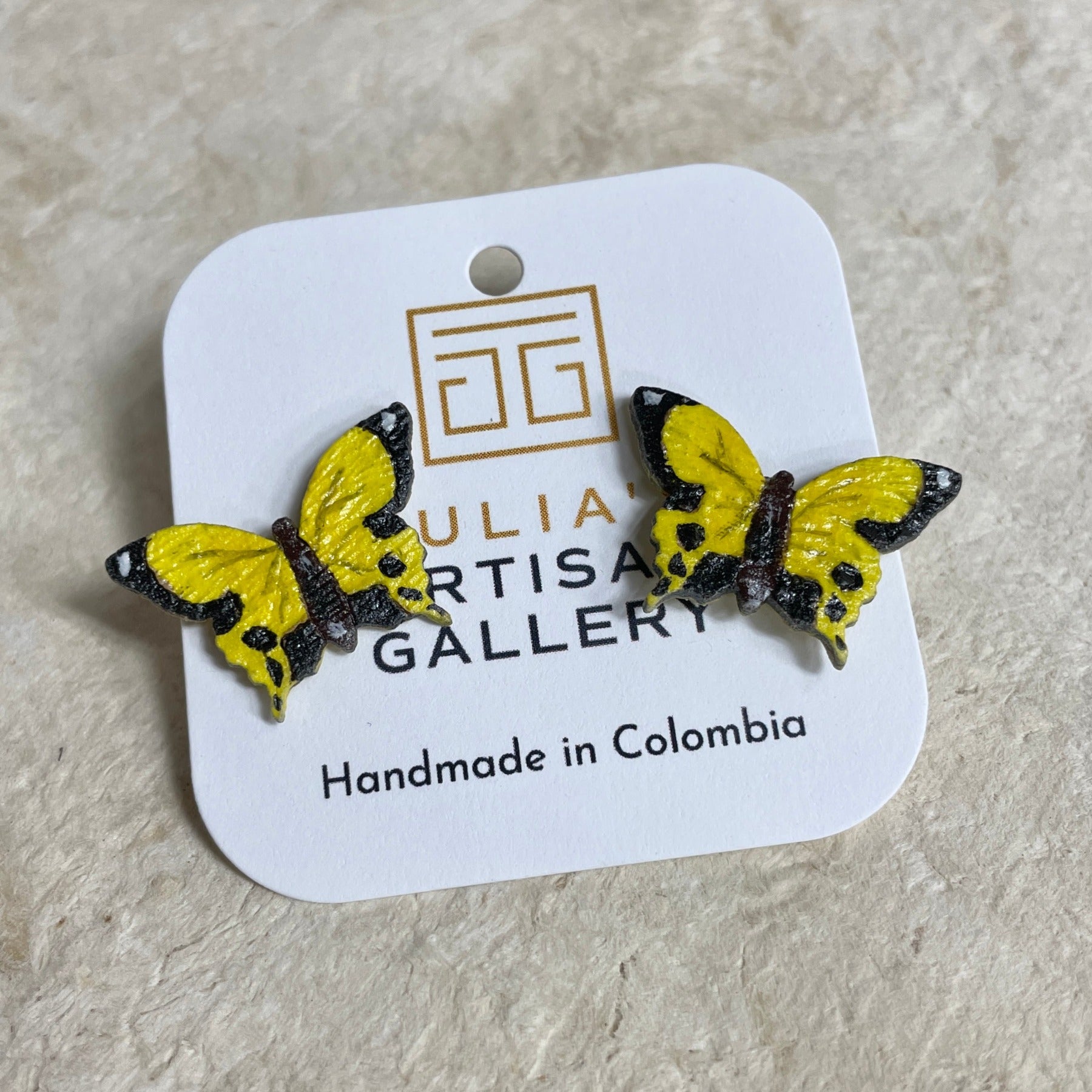 Yellow butterfly earring studs in package.