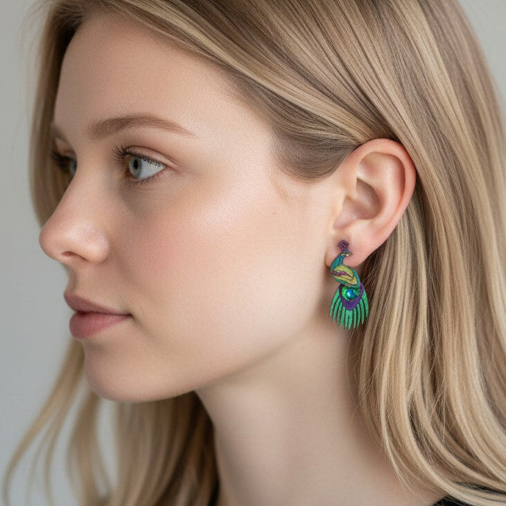 Woman wearing colorful earrings with a neutral background