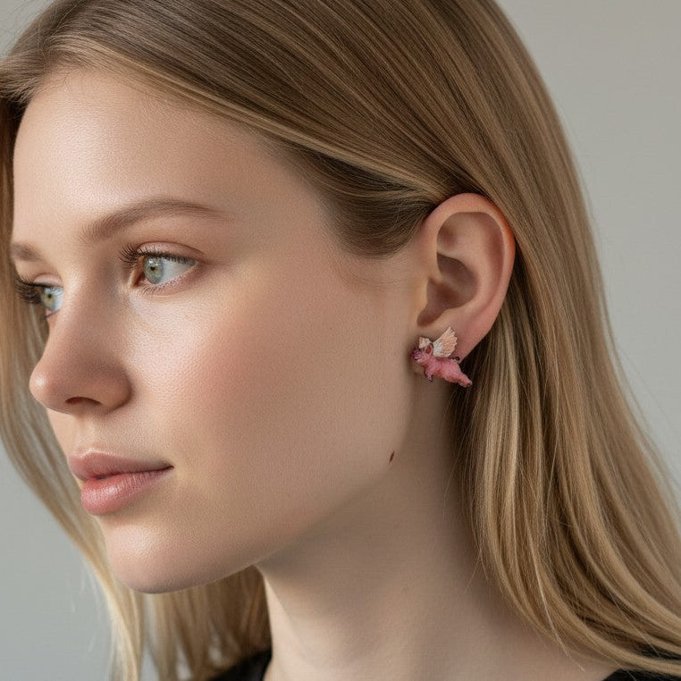 Woman wearing pink floral earrings against a neutral background