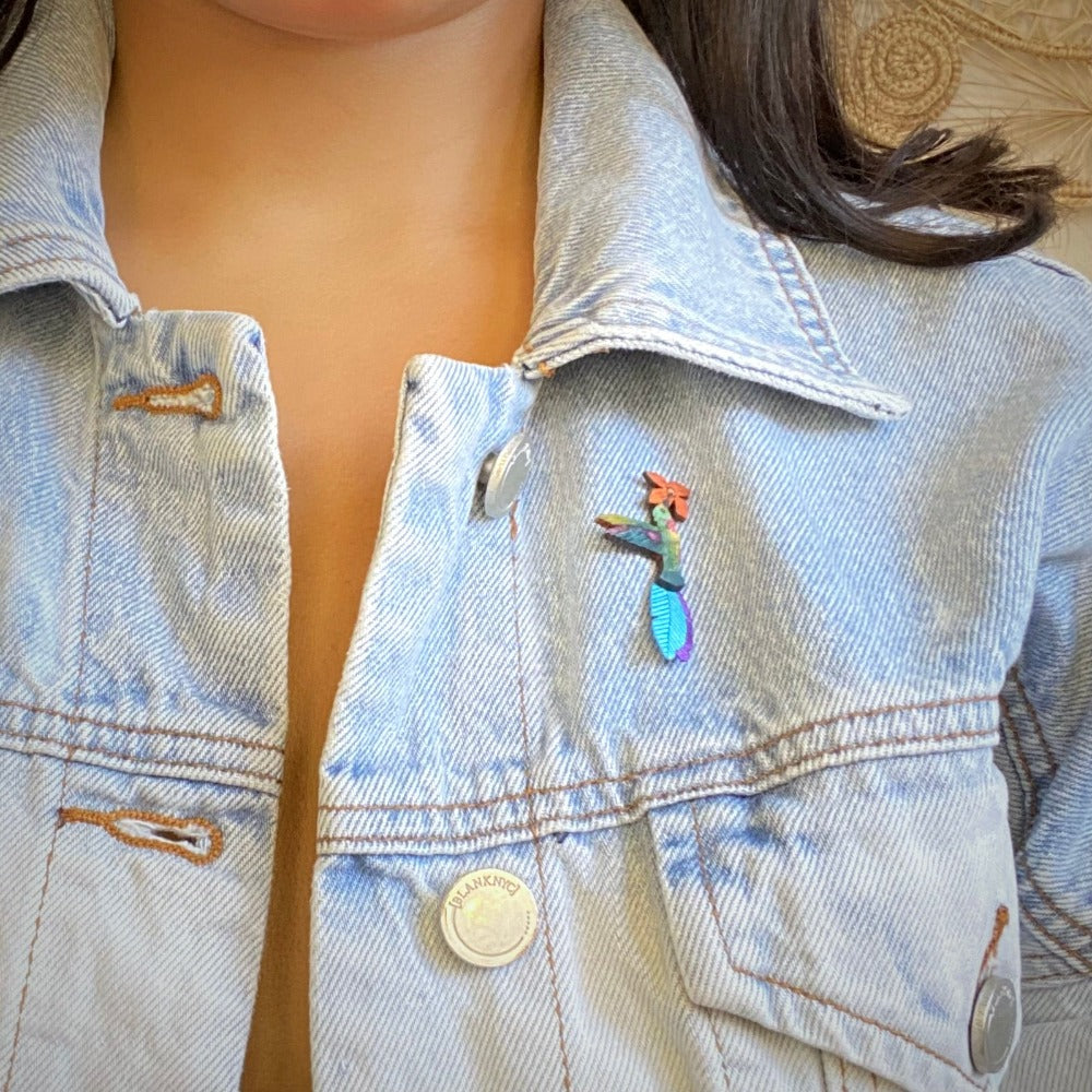 Ruby Throated hummingbird brooch pin on jean jacket worn by model. 