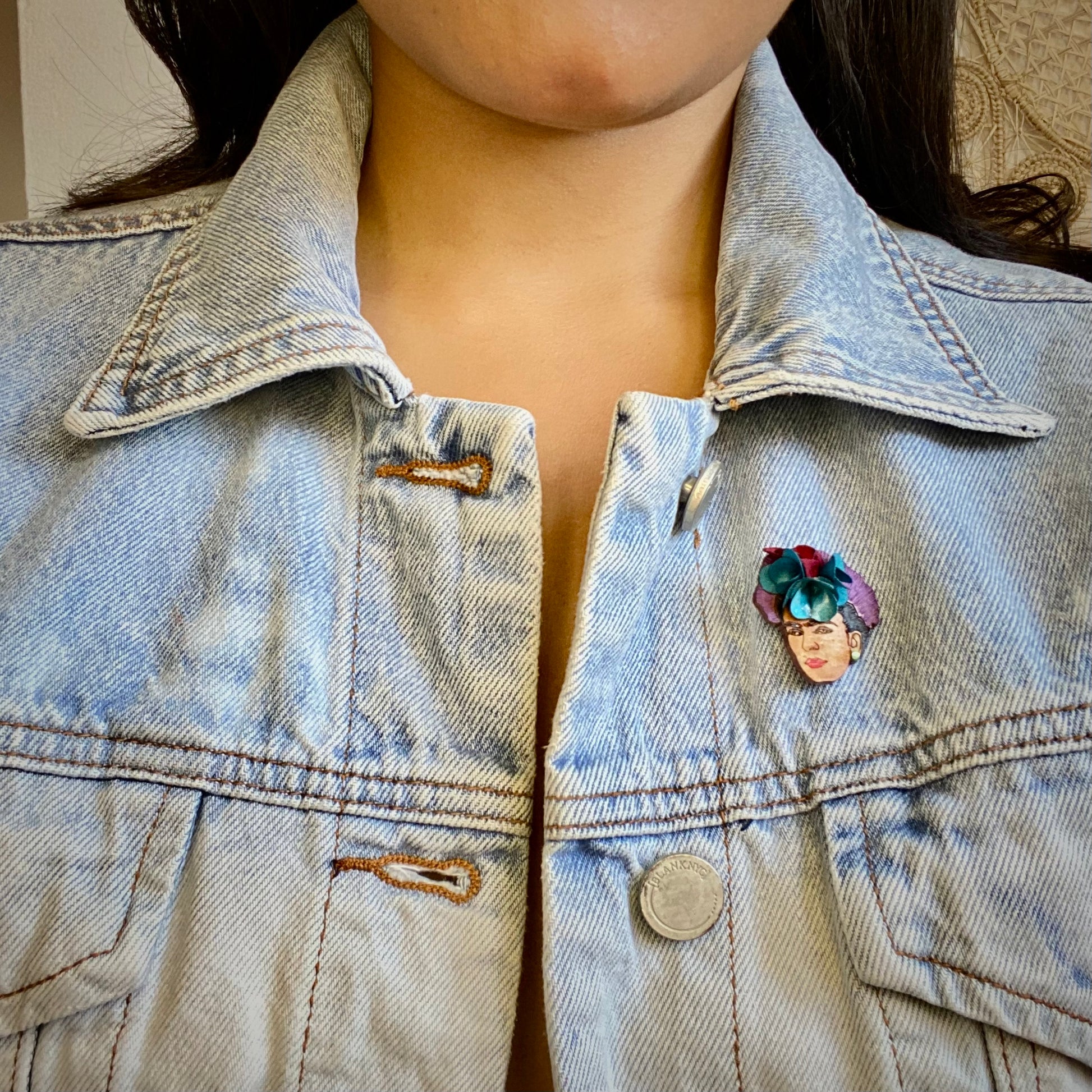 Frida Kahlo brooch pin on model wearing a jean jacket. Handmade in Colombia. 