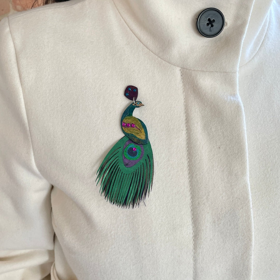 Peacock Brooch on model wearing a white coat.